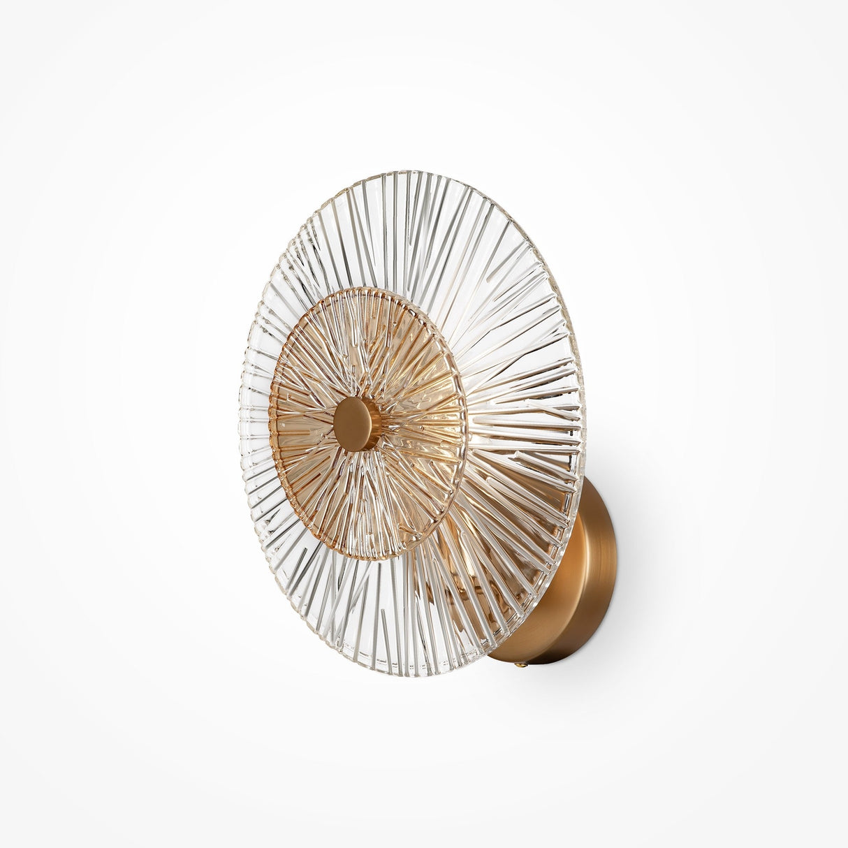 The Aster Wall Light in gold features a modern circular design with a sunburst pattern of thin metallic rods radiating from a central glass disc. It provides ambient lighting, has a clear outer section, and is mounted on a round base.
