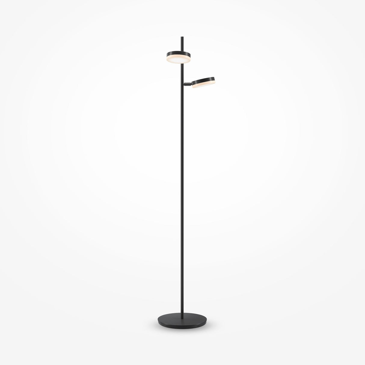 The Fad LED Floor Lamp in black features a minimalist design with a round base and tall slender pole, supporting two differently sized circular light fixtures. One fixture faces upwards while the other angles to the side, providing soft, energy-efficient lighting against a white backdrop.