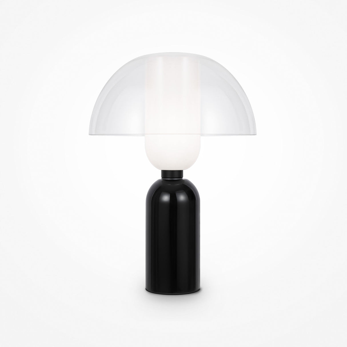 The Memory Table Lamp - Black showcases a black ceramic base and a dome-shaped opal white glass shade. Its minimalist, sleek design effortlessly elevates any rooms decor.