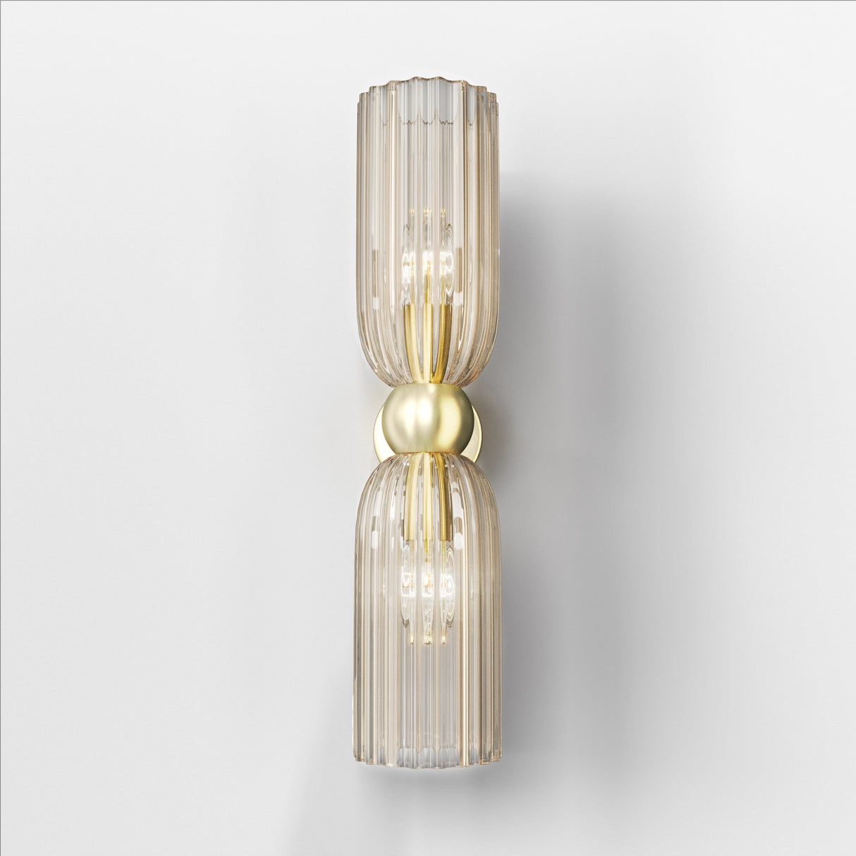 The Antic 2 Light Wall Light, featuring ribbed cognac glass shades and a central round brass element, displays visible bulbs in a warm retro style against a white wall.