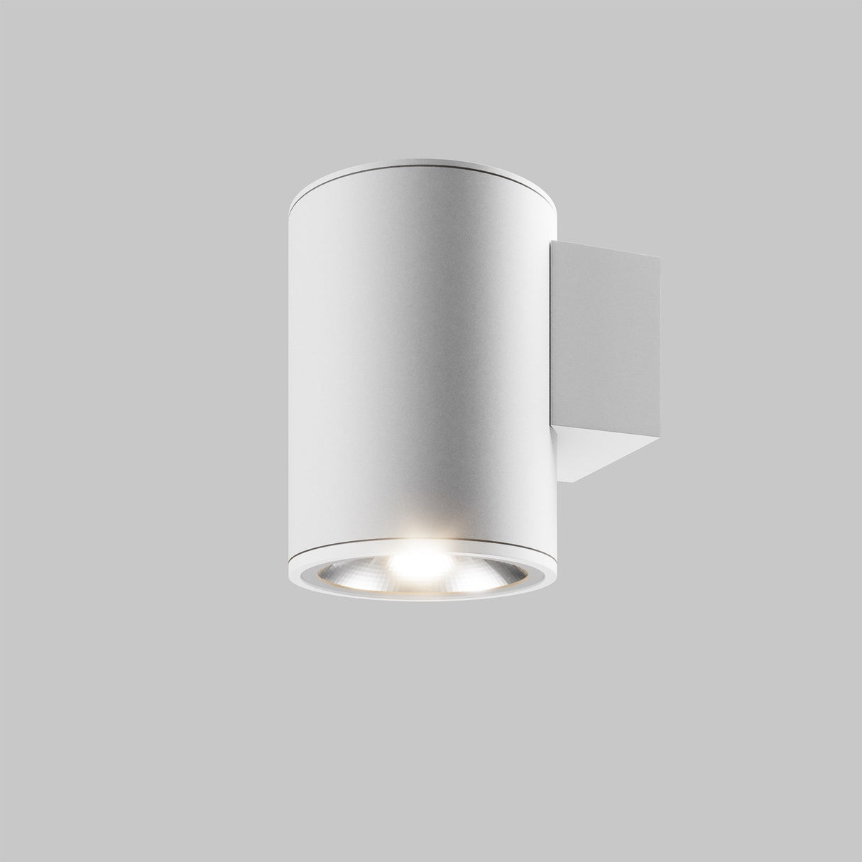 The Shim Outdoor Wall Light 5W 3000K - White is a sleek, modern cylindrical fixture with an IP65 rating and a smooth white finish, offering bright downward illumination against a light gray background.