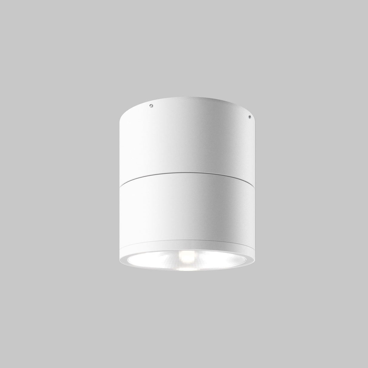The Spin Outdoor LED Single Spotlight 12W 3000K - White is a cylindrical ceiling fixture with a smooth white finish against a gray background. With an IP54 rating, it directs its 3000K LED light downward for focused outdoor illumination.