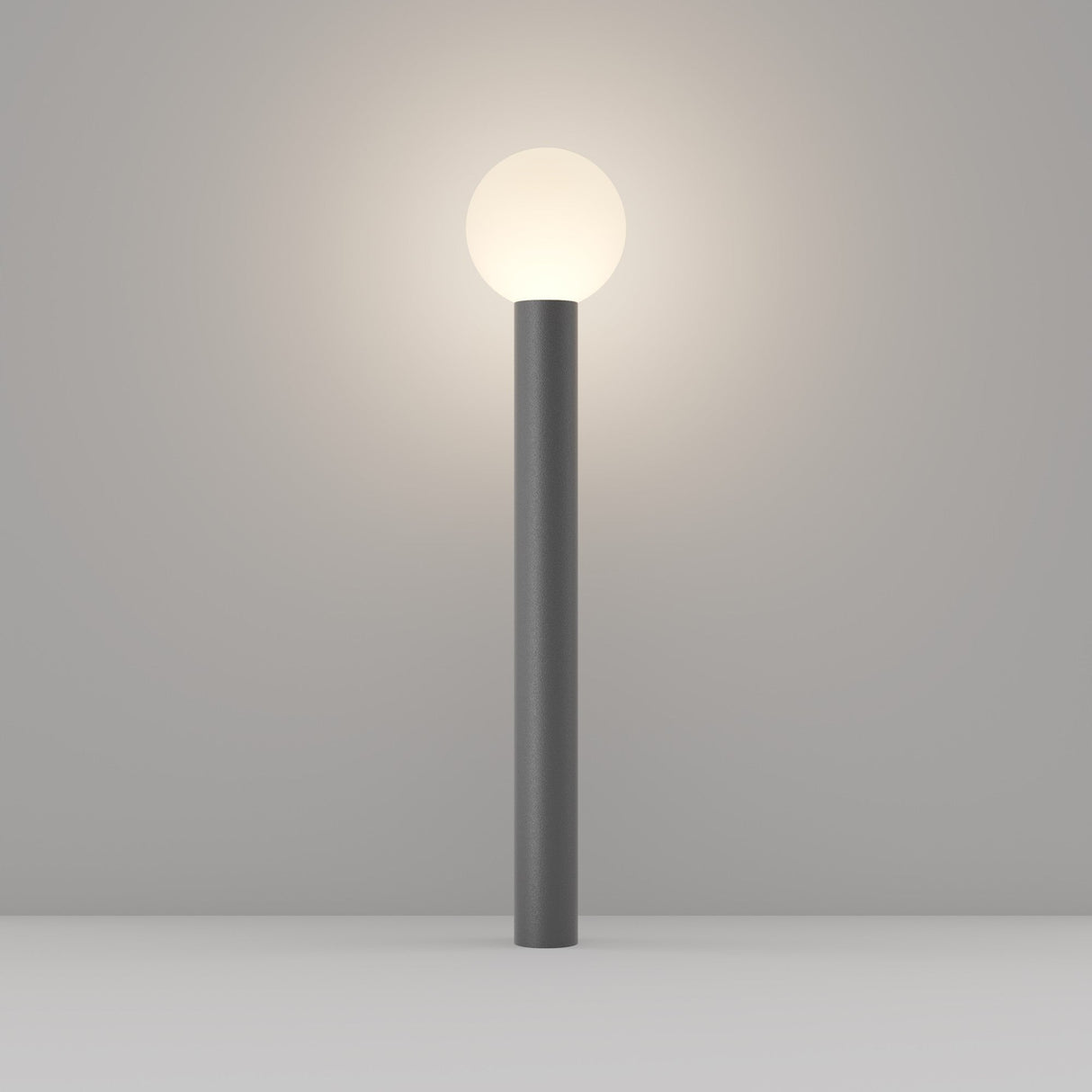 The Bold Bollard Light 80cm - Grey is a minimalist floor lamp featuring a cylindrical gray base and a glowing spherical white light, showcasing modern design on a neutral gray background.
