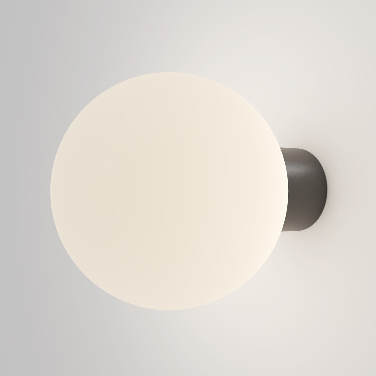 The Bold Outdoor Wall Light - Black (O598WL-01B1) features a minimalist design with a spherical frosted glass shade that emits a soft, warm glow. Its IP65-rated dark circular base ensures durability and ambiance, making it perfect for modern outdoor settings.