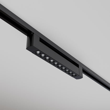 The Points Rot LED Swivel Linear Track Light, mounted on a white ceiling, has a sleek, black rectangular design with multiple small bulbs in a row. It delivers 4000K cool white light for a minimalist and contemporary look.