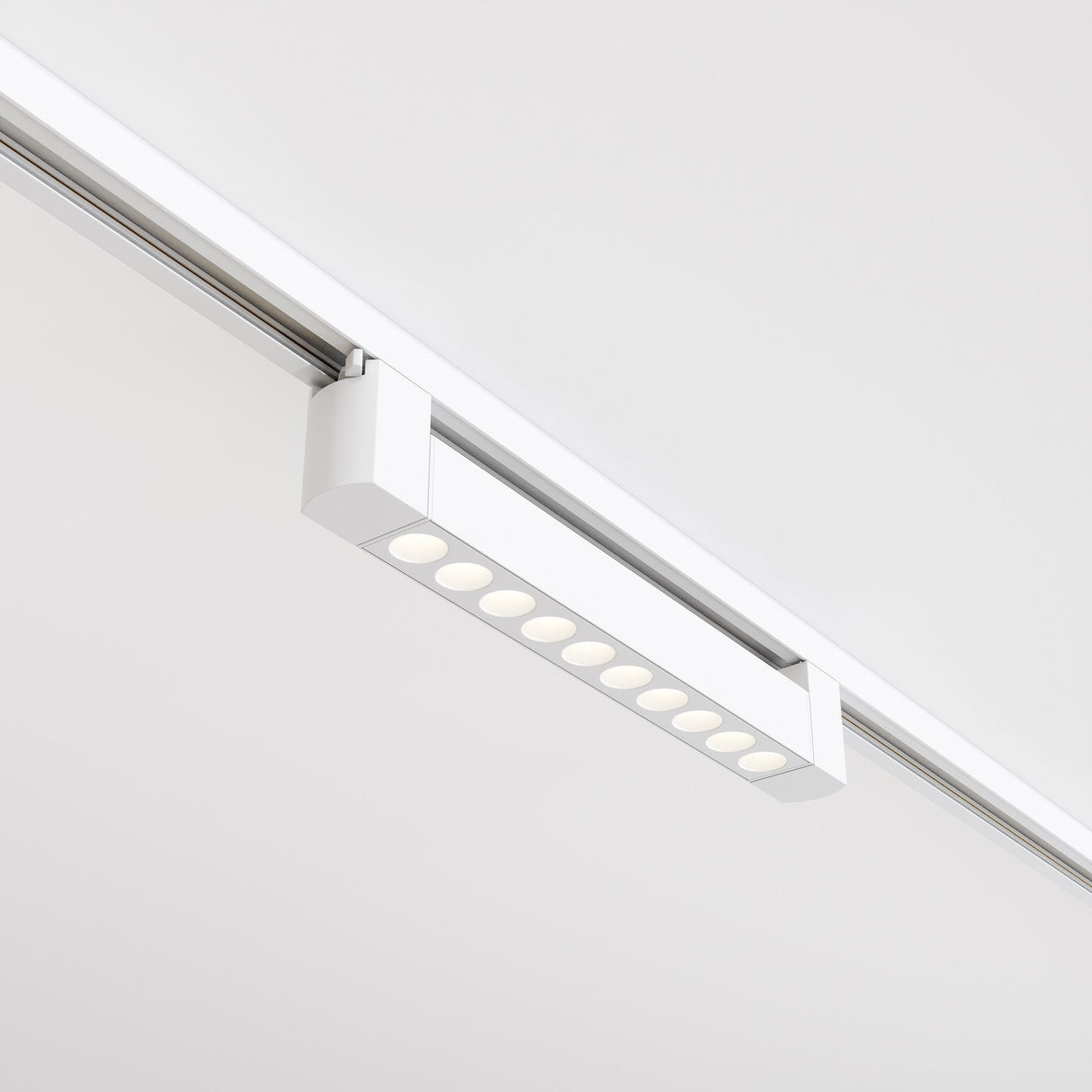 The Points Rot LED Swivel Linear Track Light offers a sleek, modern design. It features a 10W bulb with 4000K light temperature and a high CRI, mounted on a white ceiling to complement the rooms contemporary style seamlessly.