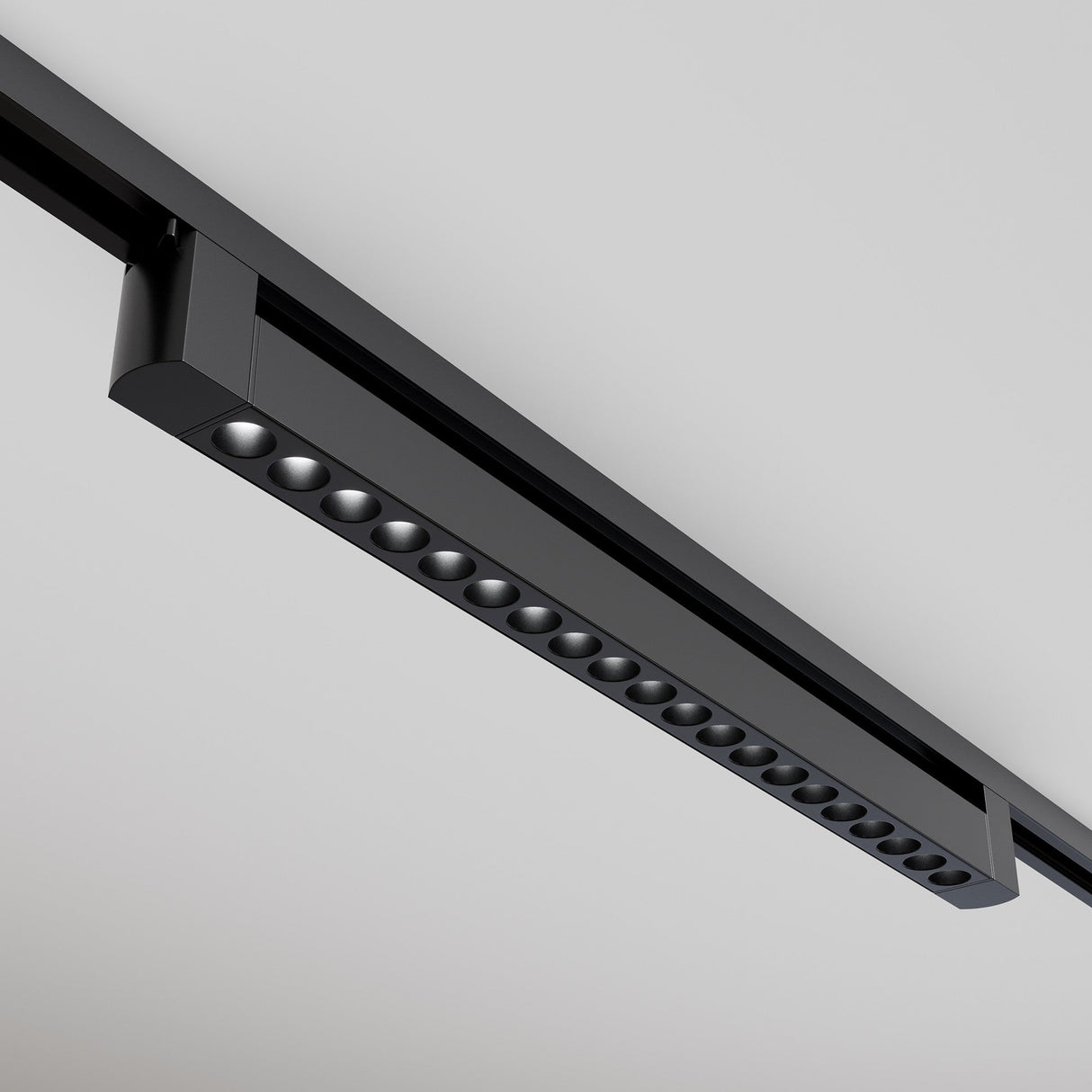 Mounted on a white ceiling, the black Points Rot LED Swivel Linear Track Light offers a modern look with its linear design and aligned round LED lights, providing a minimalist and sophisticated appeal with warm 3000K illumination.