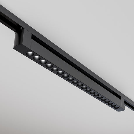 Mounted on a white ceiling, the black Points Rot LED Swivel Linear Track Light offers a modern look with its linear design and aligned round LED lights, providing a minimalist and sophisticated appeal with warm 3000K illumination.