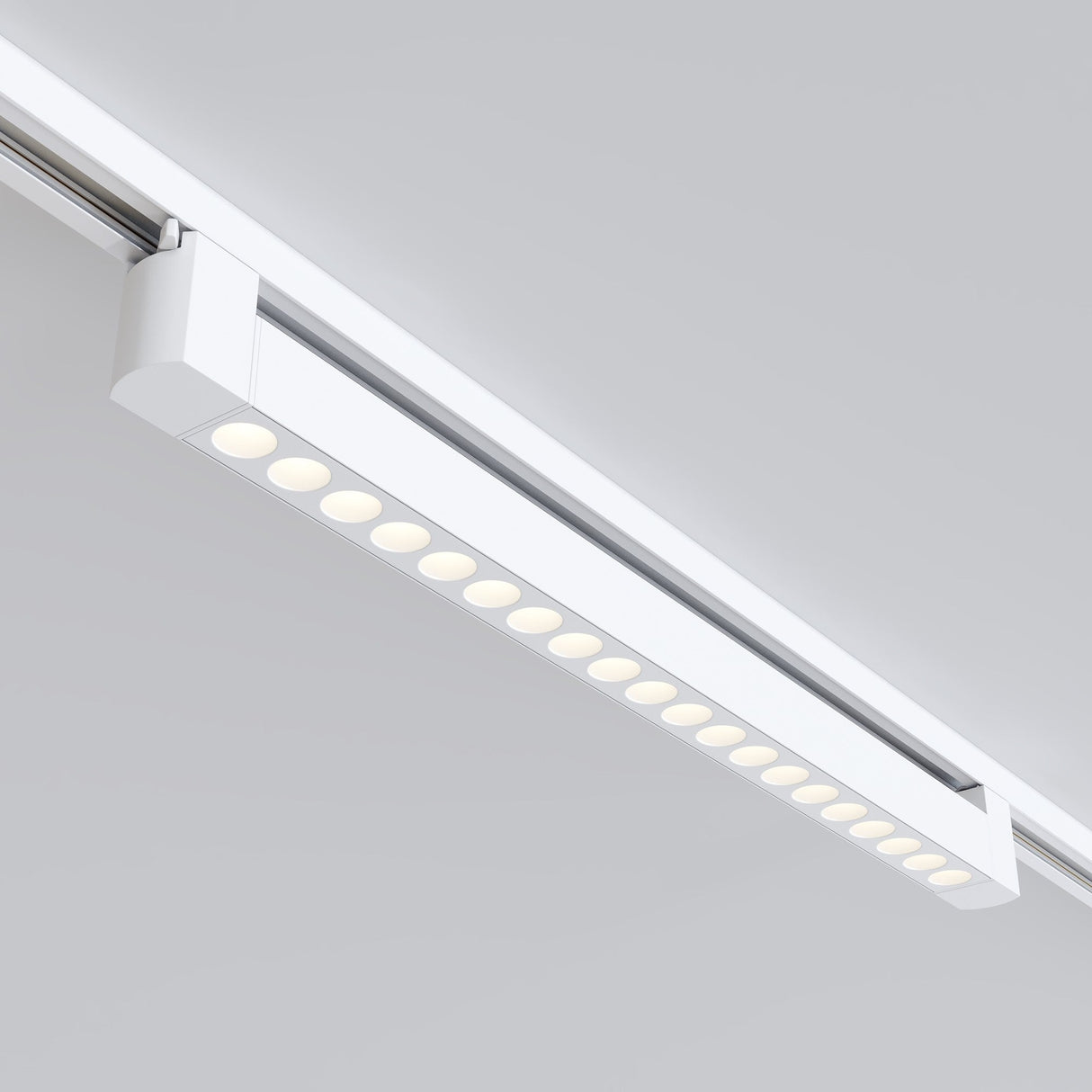 The Points Rot LED Swivel Linear Track Light for Single Phase Track Unity (20W, 3000K, 36°) offers modern elegance with warm white lighting. Its rectangular design has clean lines and a minimalist look, standing out elegantly against light gray ceilings.