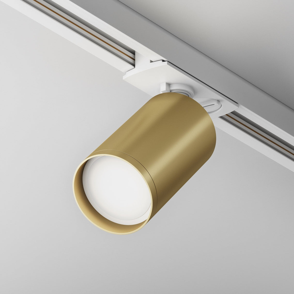 Focus S single phase Unity track spotlight in white and matte gold, highlighted in a modern interior setting.