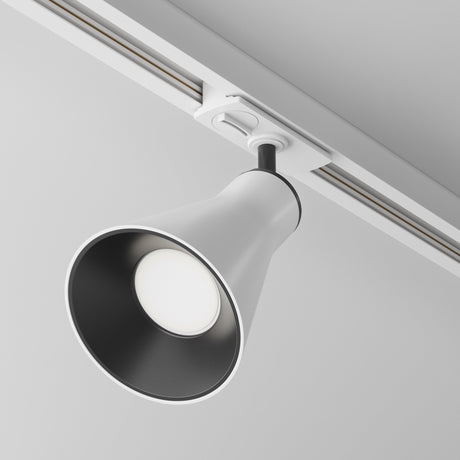 The Virar Single Phase Unity Track Spotlight in white is a modern cone-shaped LED track light with a black interior, mounted on a ceiling rail. It has a GU10 lamp base and an adjustable head, providing directional lighting with its minimalistic design.