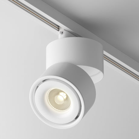 The Yin LED Single Phase Unity Track Spotlight 15W 3000K in white features a circular, cylindrical design. It mounts on ceilings, displaying a visible bulb that casts soft light at a 3000K color temperature and enhances contemporary interior aesthetics with its minimalist style.