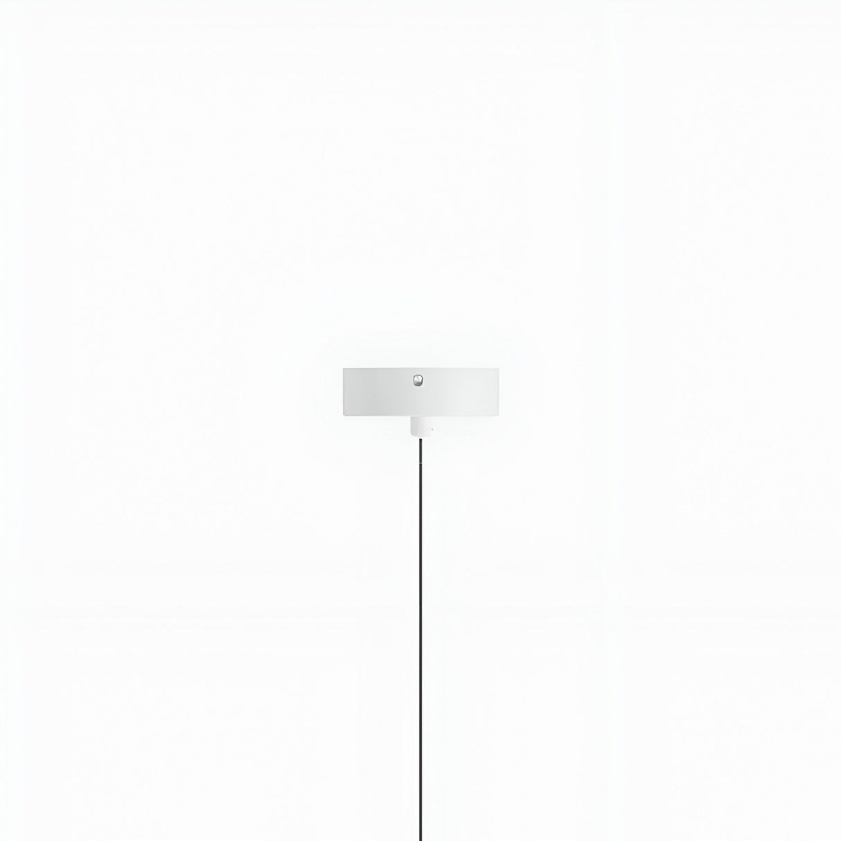 The Micro LED Pendant Light - White features a minimalistic rectangular shade mounted on a white wall. Its adjustable LED lighting and black power cord create a striking contrast against the clean, minimalist background.
