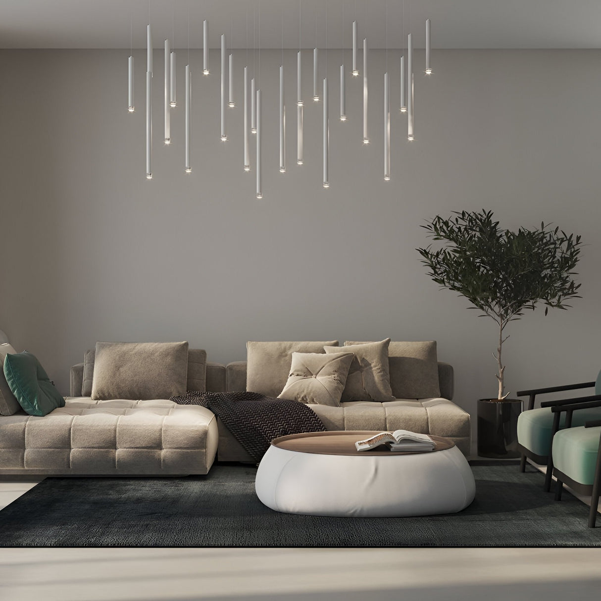 A modern living room features beige sofas, a large round ottoman coffee table, a black rug, a tall indoor plant, and multiple Micro LED Pendant Light - Silver fixtures against a light gray wall.