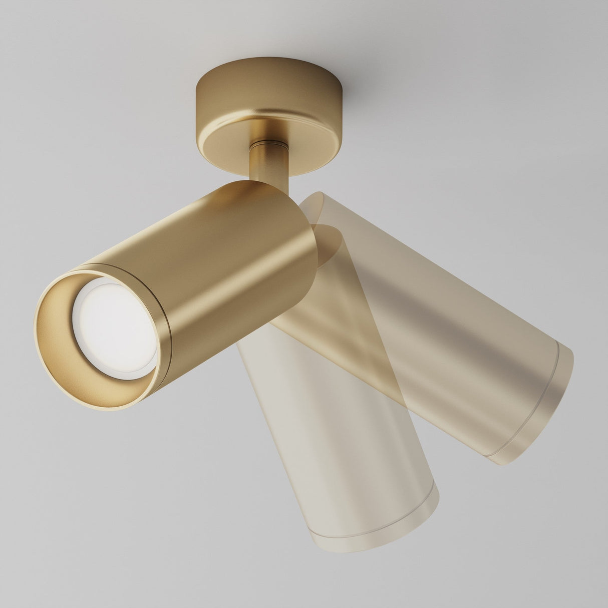 The Focus Single Surface-Mounted Spotlight in matte gold features a sleek, cylindrical design and adjustable light. It is shown in motion against a plain, light-gray background, with light cascading downward.
