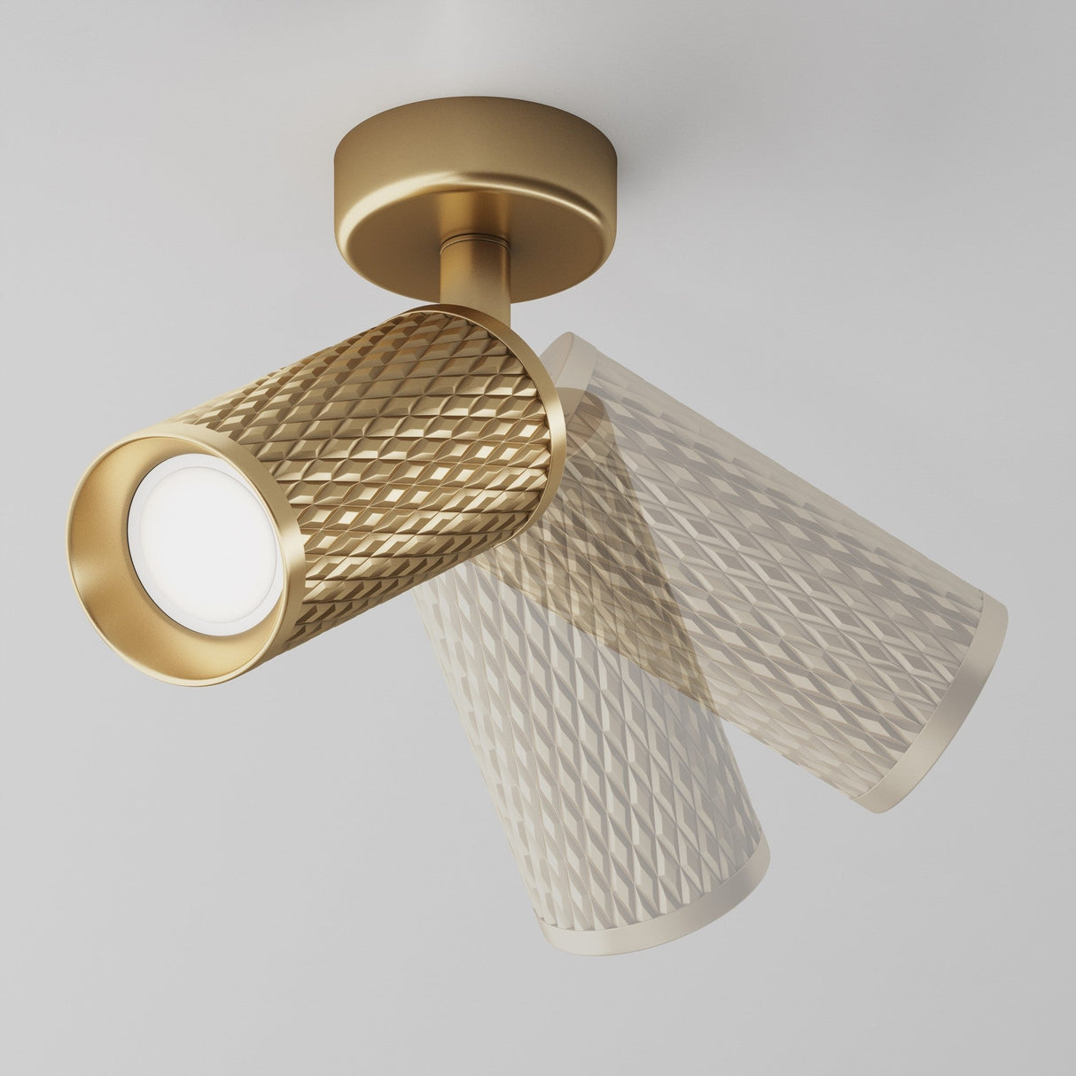 The Focus Design Single Spotlight in matte gold offers a ceiling-mounted, cylindrical design with a textured diamond pattern. Its swivel mechanism allows for directional lighting adjustments, making it ideal for casting a warm accent glow.