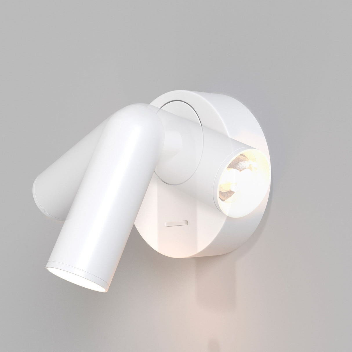 The Mirax LED Swivel Round Wall Light in white is a modern, wall-mounted, adjustable spotlight featuring a cylindrical design on a round base. It enhances minimalism with energy-efficient LEDs casting a directed beam on a gray wall.