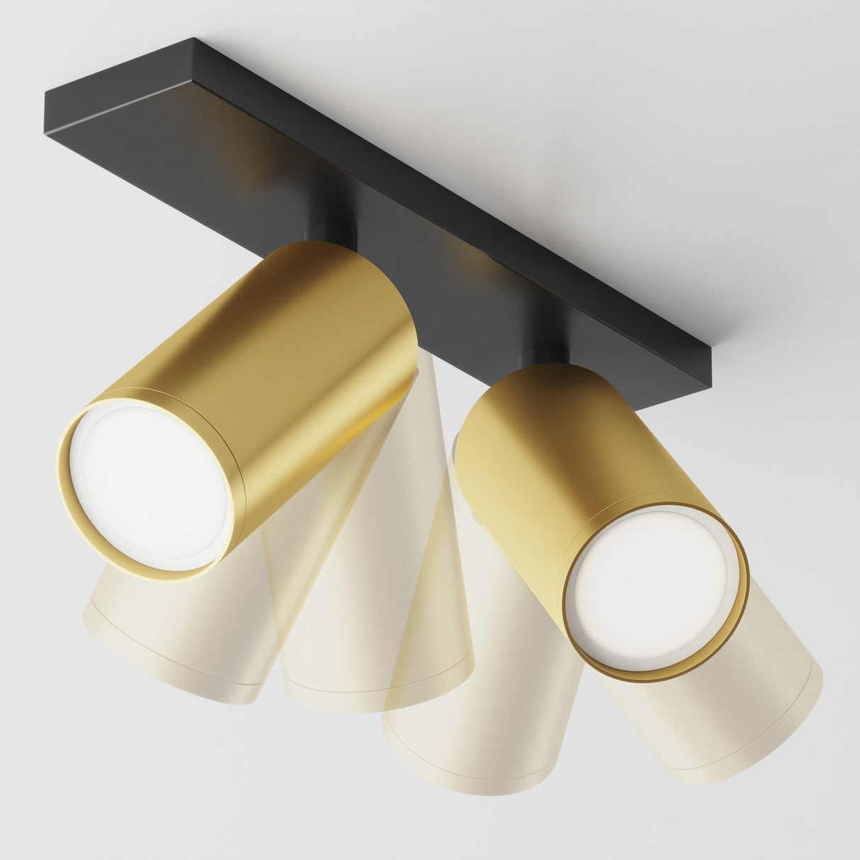 The Focus S Twin Bar Spotlight in black and matte gold features two adjustable cylindrical spotlights on a rectangular black base, angled downward against a white background.