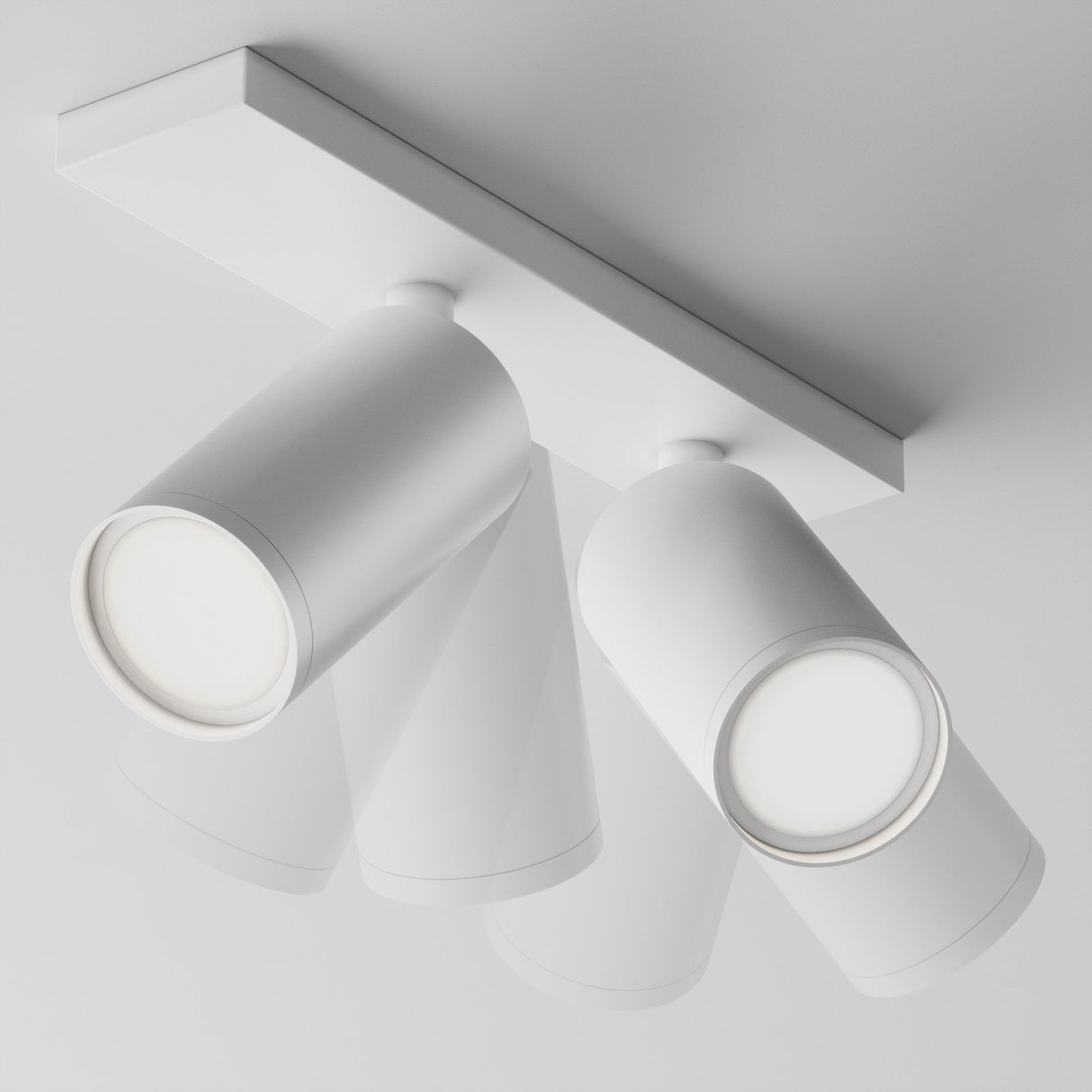 The Focus S Twin Bar Spotlight - White is a modern, minimalist ceiling-mounted fixture featuring two adjustable cylindrical lights against a sleek white design.