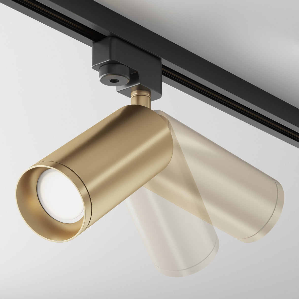 Close-up of the Focus Single Phase Unity Track Spotlight in matte gold, featuring two cylindrical heads for sleek minimalism. This GU10-compatible fixture attaches to a black track on a light gray ceiling for versatile lighting solutions.