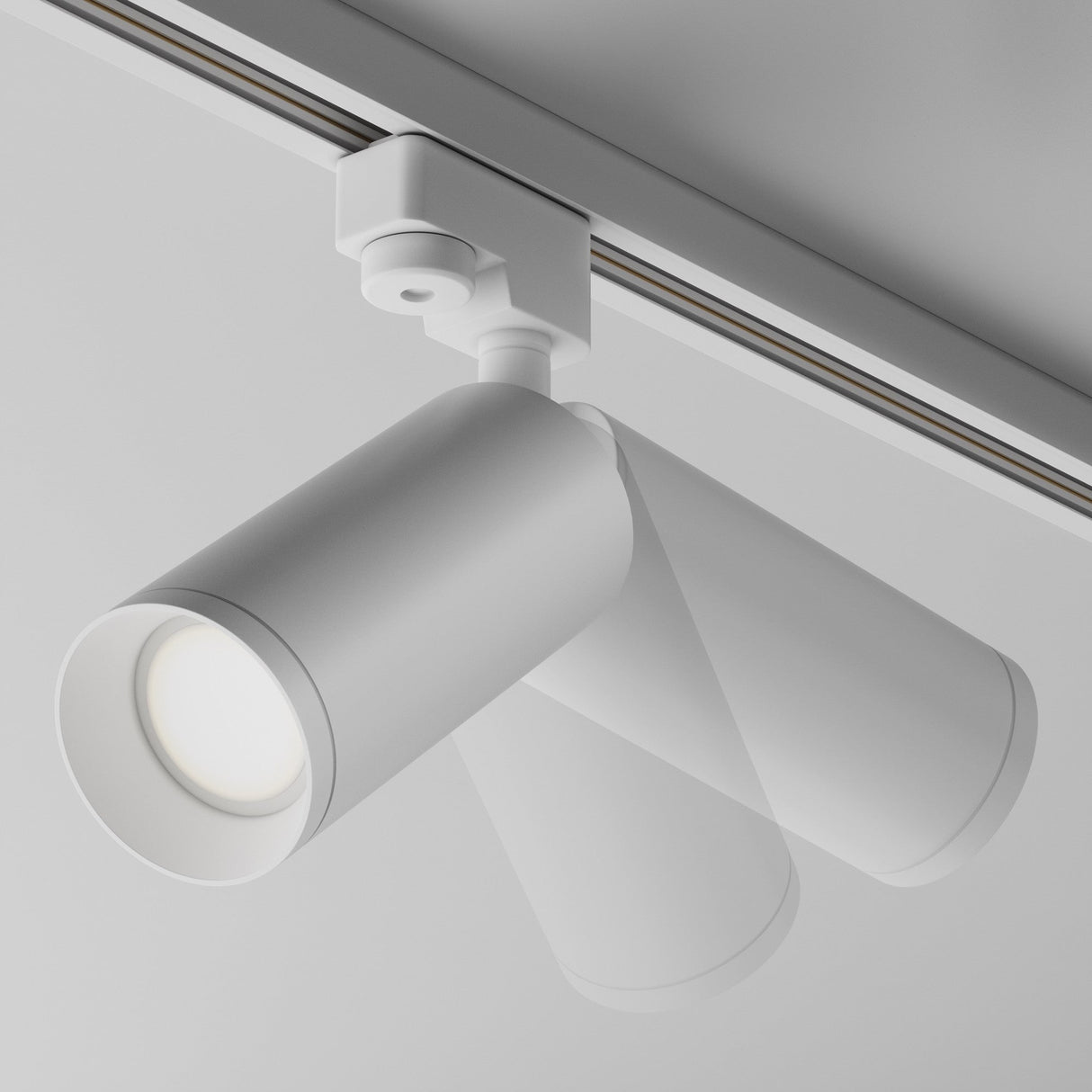 A close-up of the Focus Single Phase Unity Track Spotlight in white showcases its sleek, cylindrical design with a swivel mechanism. It features one GU10 bulb casting a soft glow and compliments contemporary interiors effortlessly with its minimalist style.