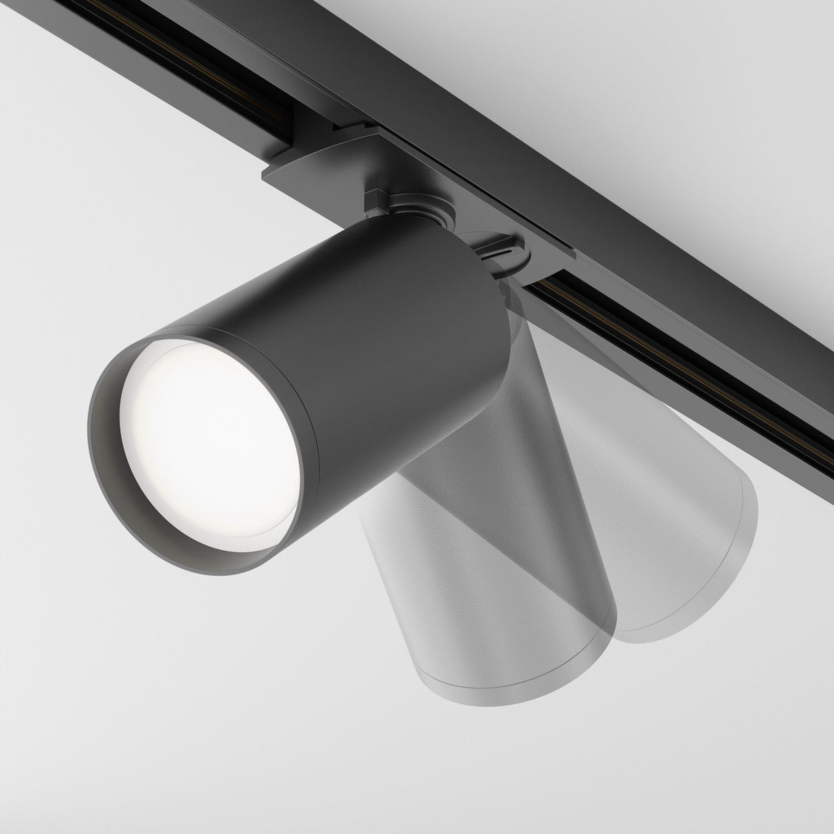 The Focus S Single Phase Unity Track Spotlight - Black is a modern, ceiling-mounted track lighting fixture with a sleek cylindrical design. It offers versatility with its ability to rotate and pivot, allowing directed illumination in various positions.