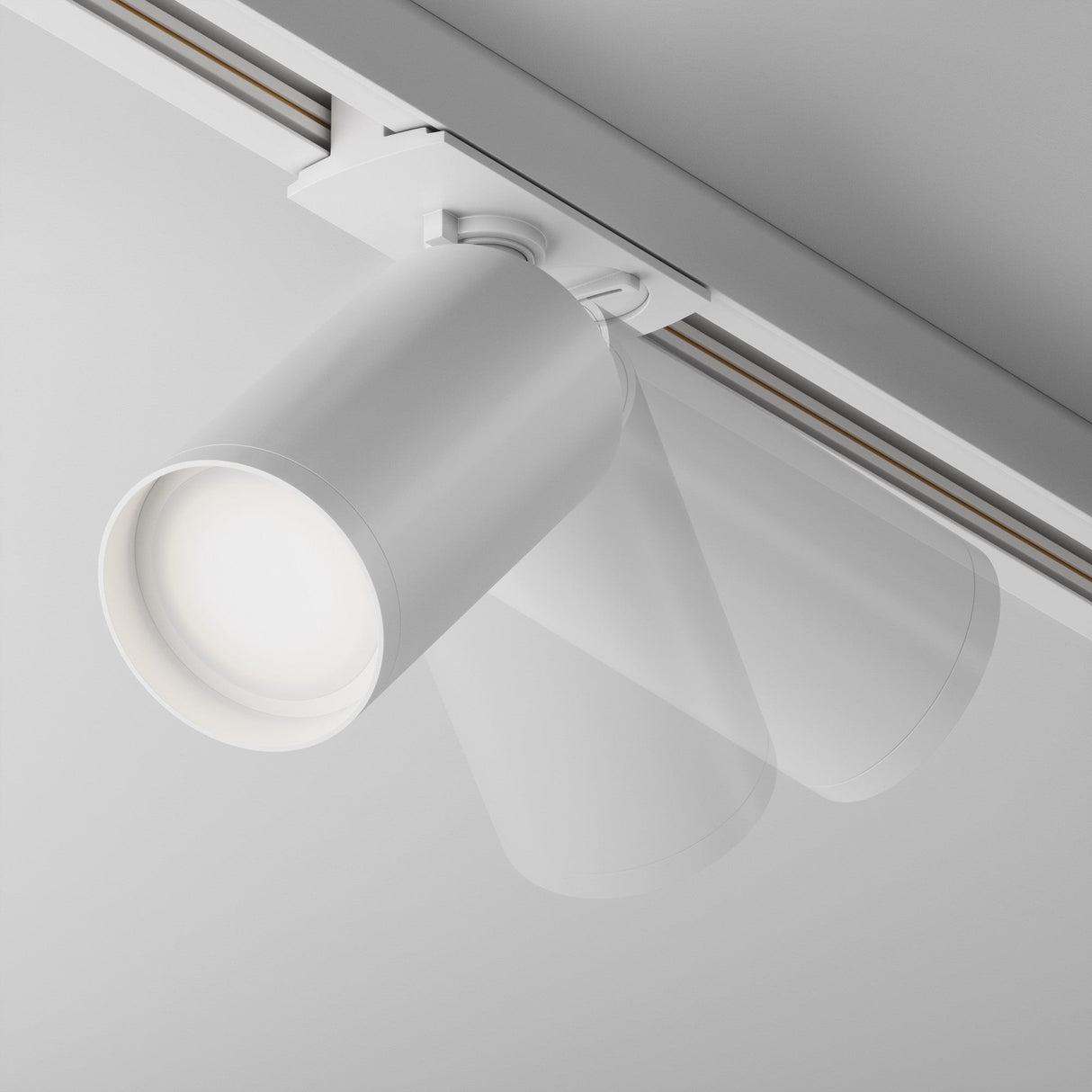 Close-up of the Focus S Single Phase Unity Track Spotlight in white, showcasing its cylindrical design. It is mounted on a ceiling track system for precision and adjustable directional lighting, illuminated to cast a glow.