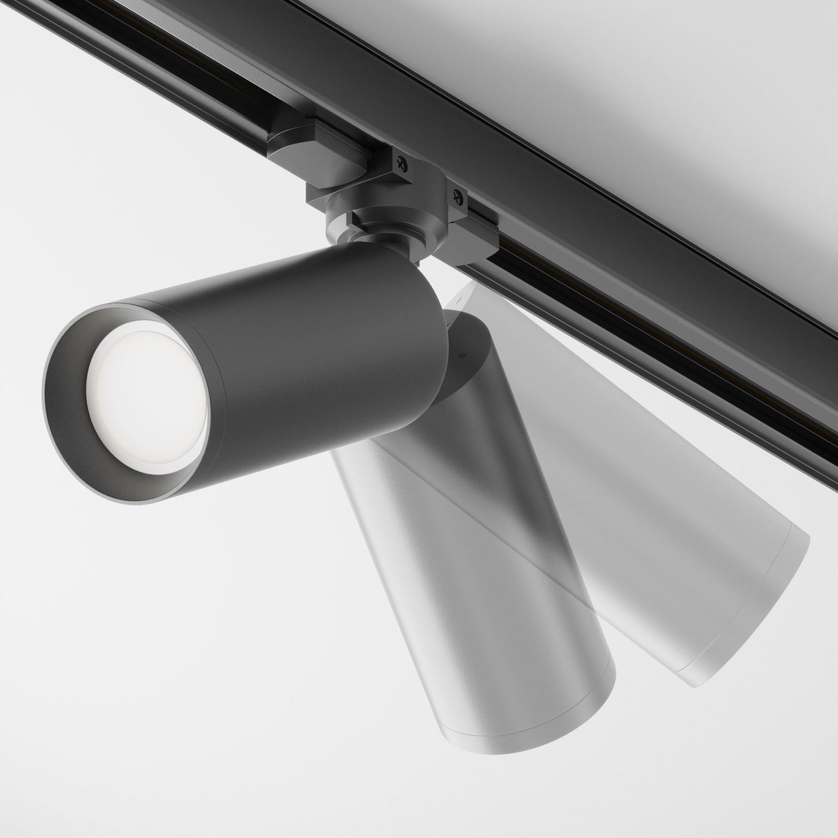 The Focus 3-Circuit Trinity Track Spotlight - Black is a sleek and modern ceiling-mounted fixture with a cylindrical spotlight featuring a circular LED bulb. Its perfect for contemporary spaces, offering adjustable positioning and focus on its linear rail.