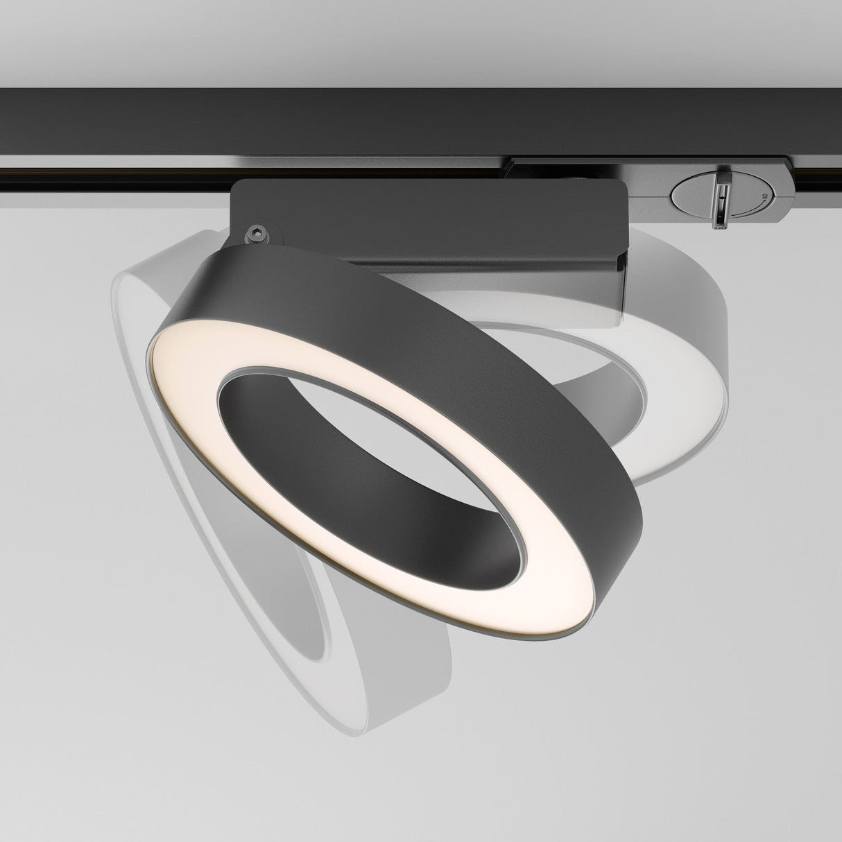 The Rim LED Single Phase Unity Track Spotlight 12W 3000K in black features a modern circular design with a white interior. Adjustable for optimal lighting, it casts an angled shadow and enhances contemporary interiors with its sleek aesthetics.