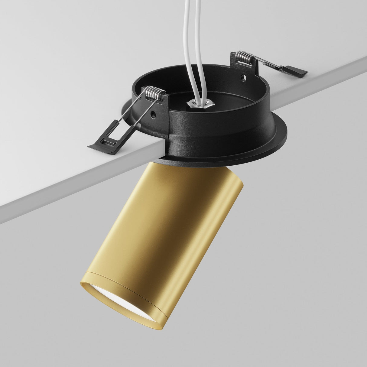 Close-up of the Focus S Single Recessed Spotlight in black & matte gold, featuring a cylindrical design with a black mounting base on a white ceiling. It offers visible wiring, adjustable metal clamps for installation, and a smooth 360° swivel mechanism for versatile lighting direction.