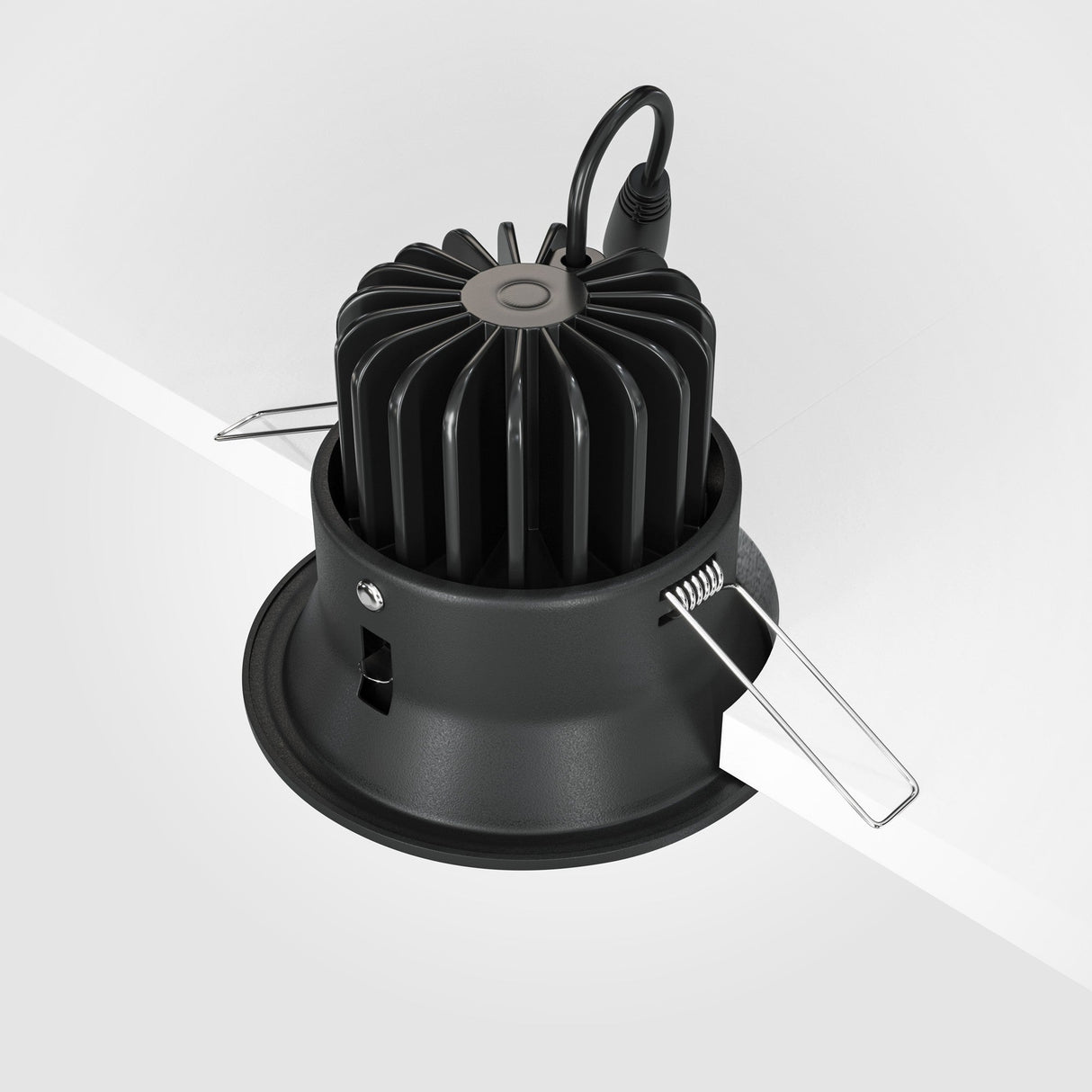 The Yin LED Dimmable Round Recessed Downlight 12W 4000K in black features a sleek aluminum frame with fins, partially inserted into the ceiling, secured by metal spring clips on the sides. A cable protrudes from its top, enhancing its modern appeal.