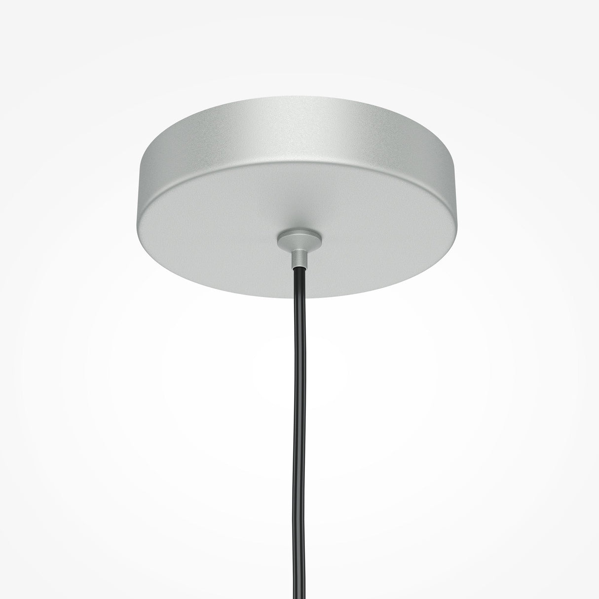 A close-up showcases the Pro Focus Thin Pendant Light - Silver, featuring a circular, polished ceiling canopy with a sleek black cord in its center, embodying modern design against a white backdrop.
