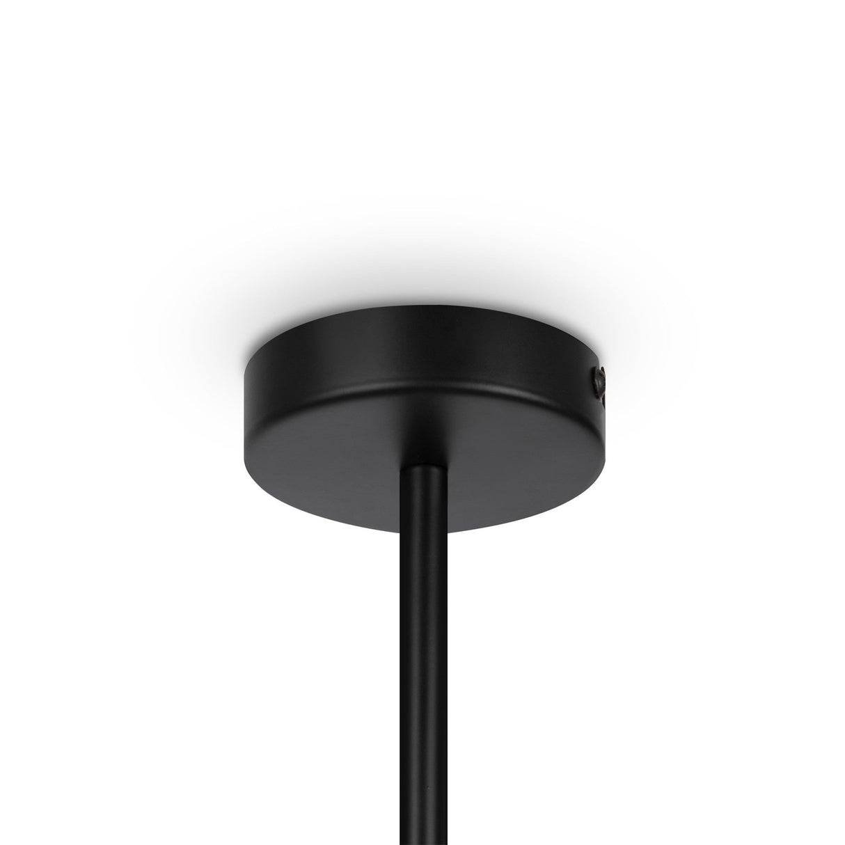 The Memory 4 Light Chandelier - Black features a minimalist design with a round base and vertical rod, elegantly contrasting against white ceilings. Its sleek, modern look offers the sophistication of a black chandelier.