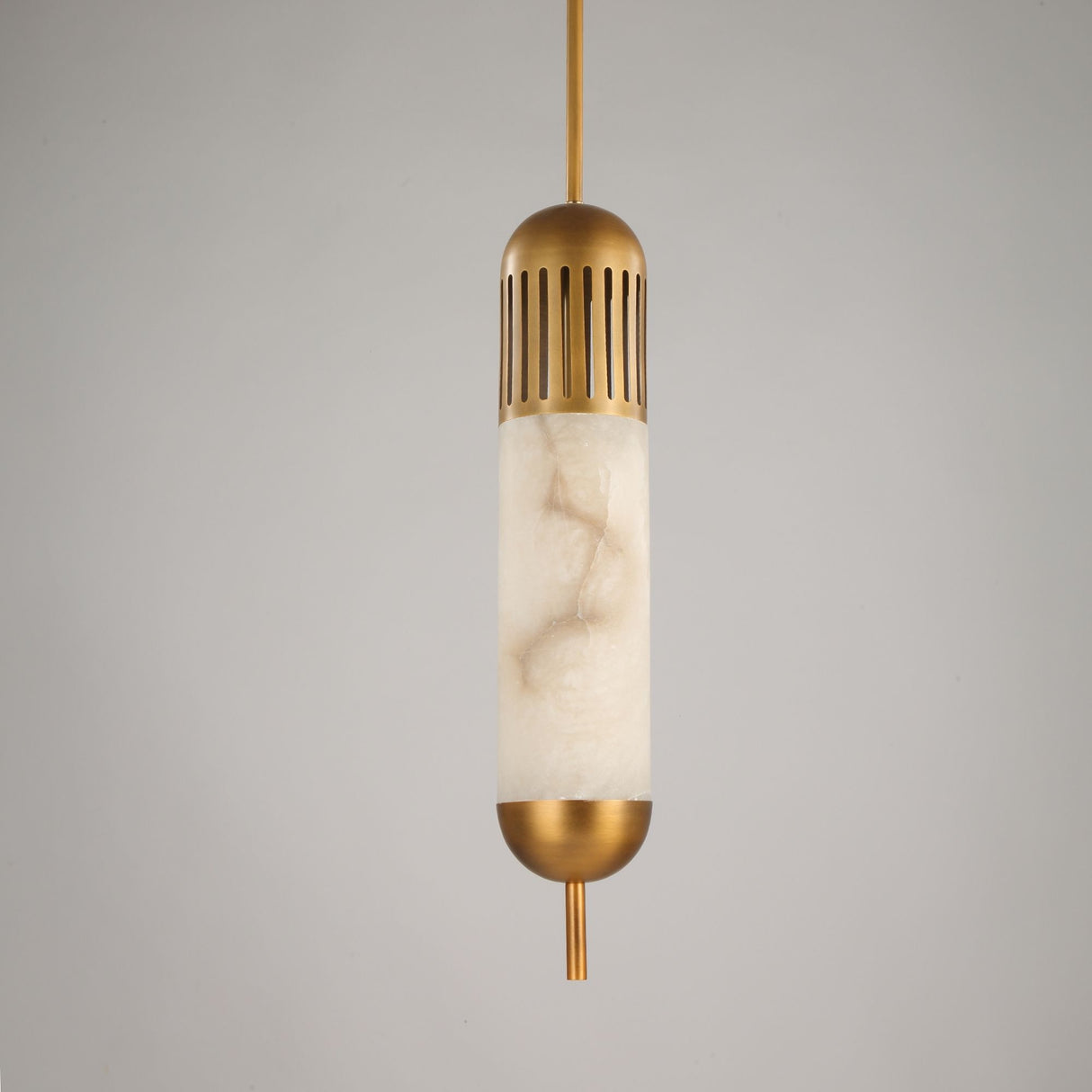 Zerith LED alabaster tube pendant light with fluted brushed brass collar and domed brass end cap, on a plain light grey background.