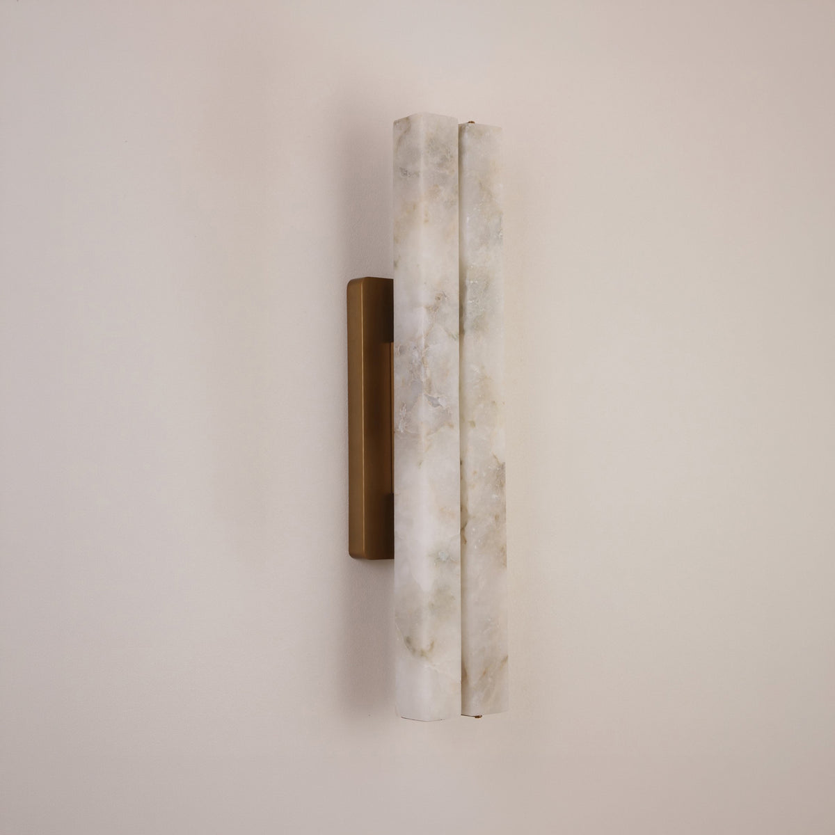Selvara LED Medium Alabaster Double Wall Light with two vertical natural alabaster bars on a brushed brass backplate, mounted on a plain neutral wall.