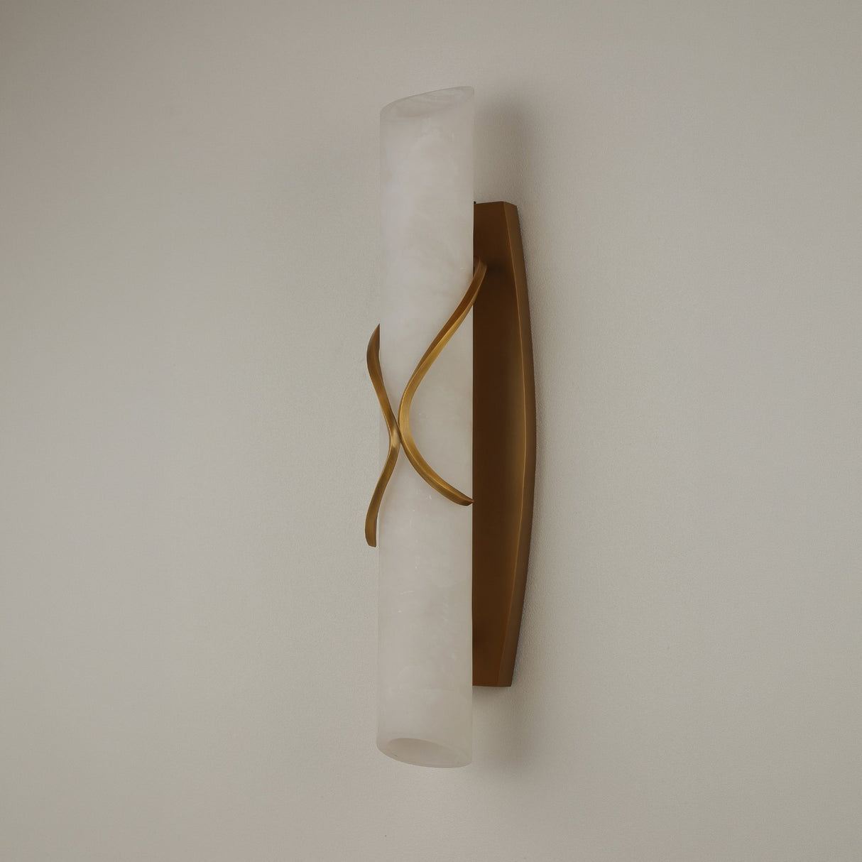 Valora LED Alabaster Wall Light in Brushed Brass, a vertical cylindrical alabaster column wrapped by curved brass bands, shown on a plain light background.