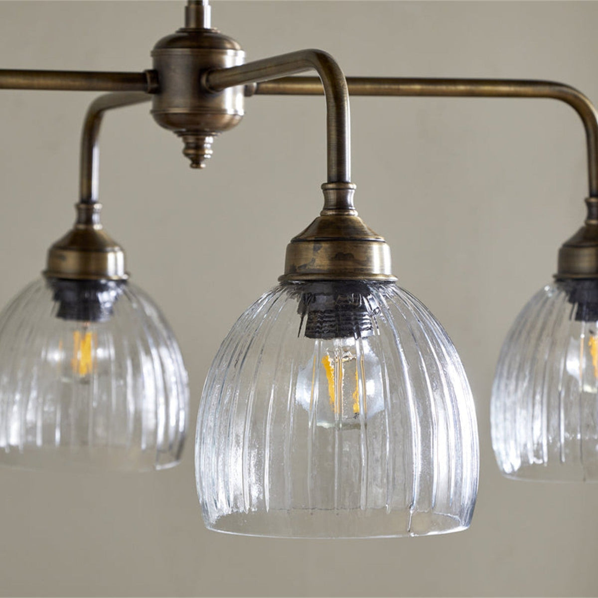 Kakira Ribbed Glass 6 Light Chandelier - Clear & Antique Brass in a dining room, view 2