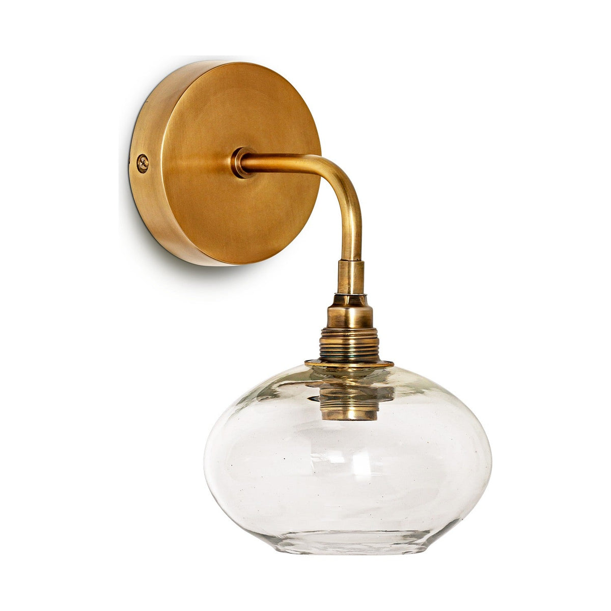 Otoro Recycled Glass Wall Light in Clear: a round brass wall plate with curved arm holding a flattened clear glass shade on a ribbed brass collar, shown on a plain white background.