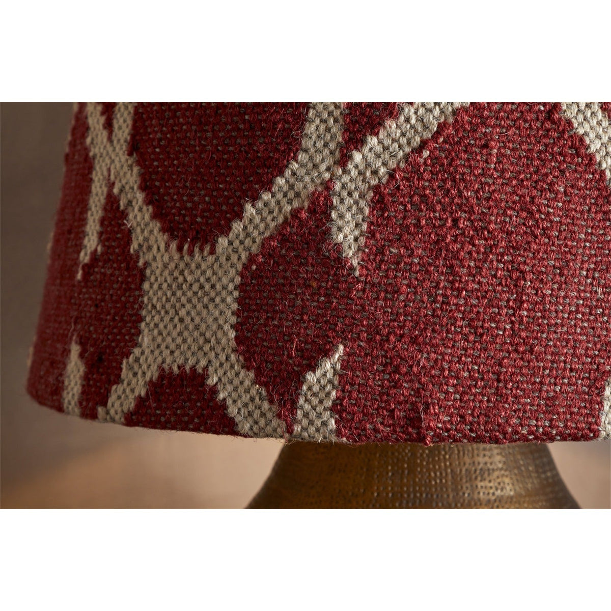 Close-up of the Haadu Large Jute Kilim Lampshade in rust and natural, showing the woven wool kilim pattern on a brass lamp base.