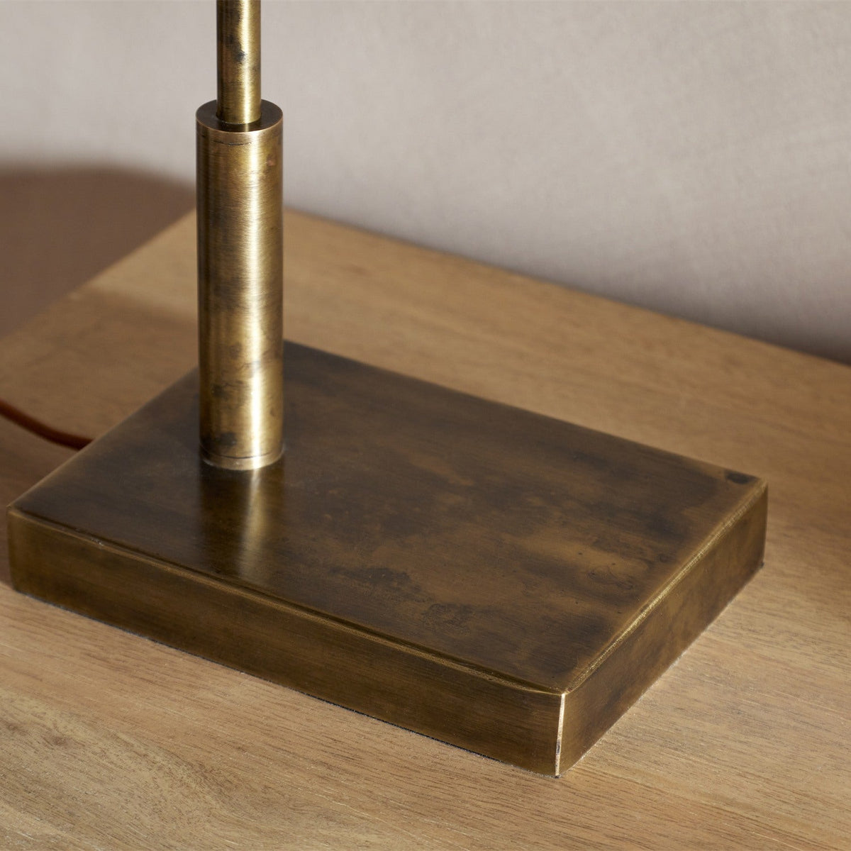 Thenkara Directional Desk Lamp - Antique Brass in a study, view 12
