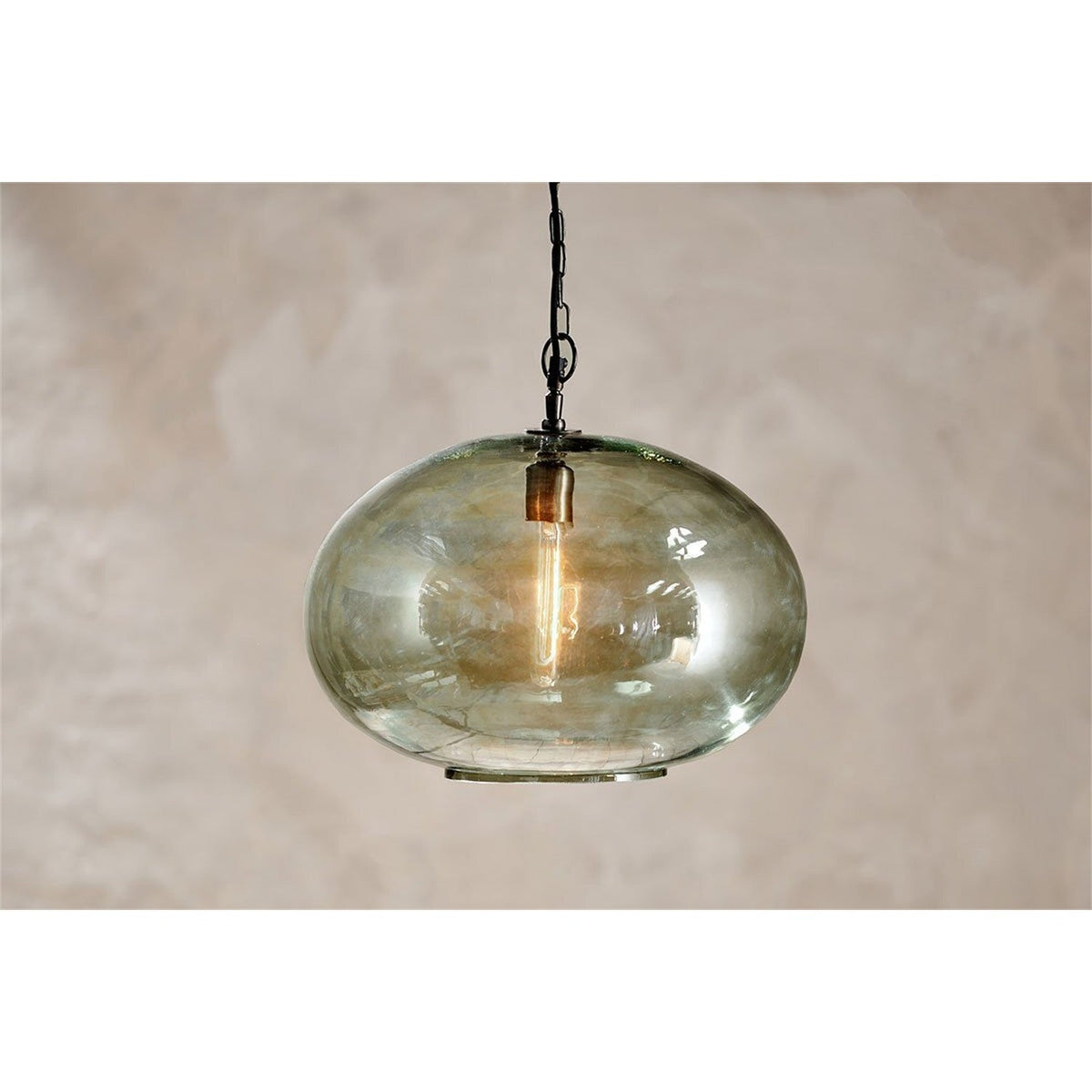 Otoro Large Round Recycled Glass Pendant Light in green, a flattened spherical shade with a brass collar and visible bulb, hung from a black chain against a plain background.