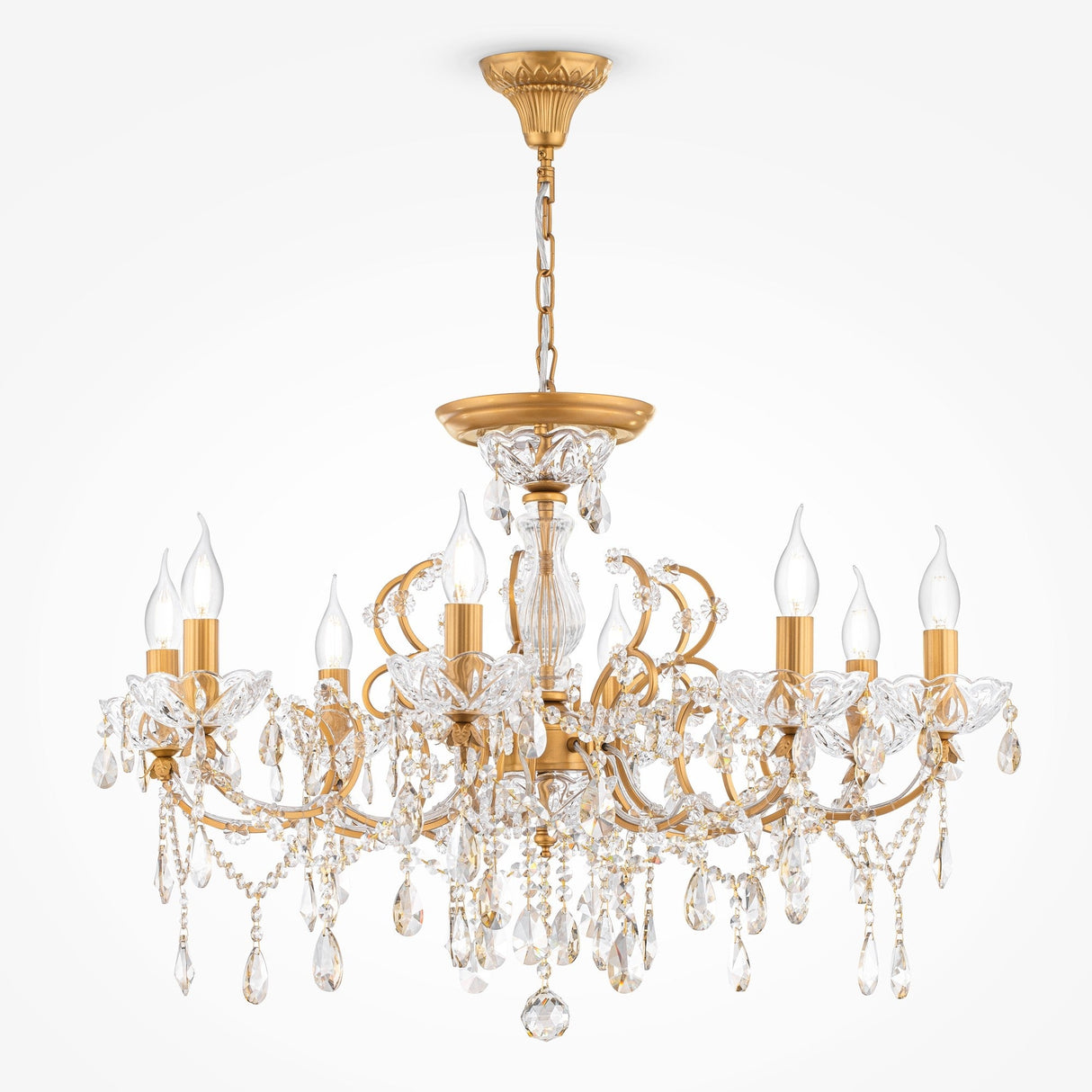 The Sevilla 8 Light Chandelier - Gold, lavishly decorated with crystals and eight flame-shaped bulbs, gracefully hangs from a matching gold chain and base against a plain white backdrop.
