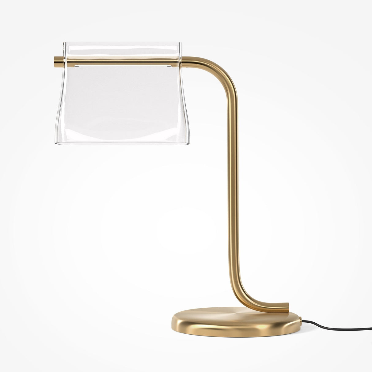 Introducing the Cabaret LED Table Lamp - Brass by Pierre Gonalons. This modern piece has a sleek, curved brass base and a transparent shade. The visible black cord adds contrast, while energy-efficient lighting creates an elegant ambiance against light backgrounds.