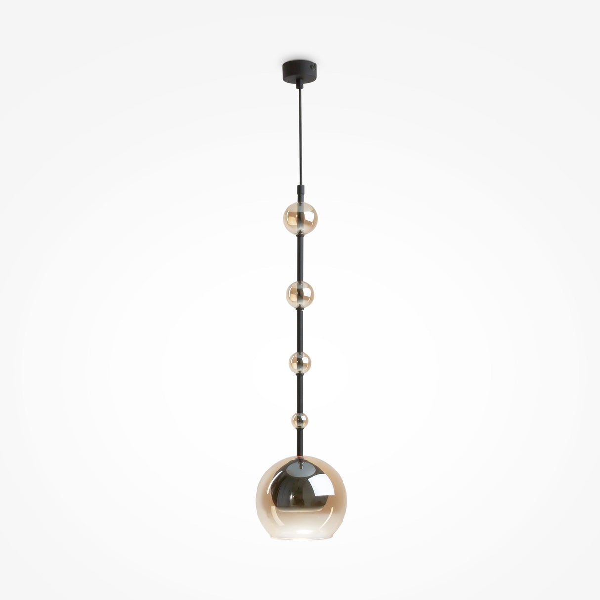 The Ros 1 Light Pendant features a black rod and five gold-tinted amber glass orbs in a minimalist design. These spherical shades increase in size from top to bottom, with the largest serving as the main light. Its sleek modern look suits any plain white setting perfectly.