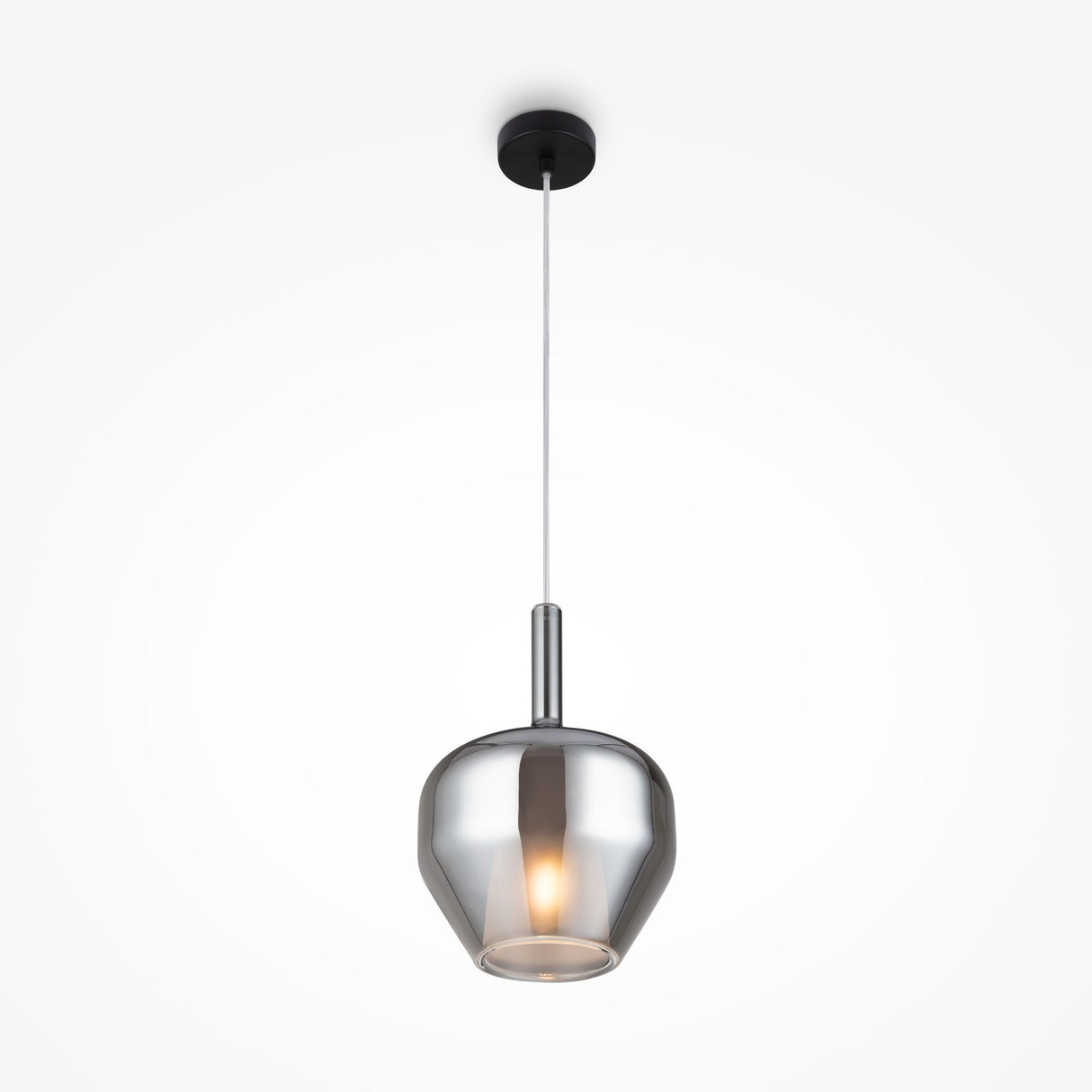 The Duality Round Pendant Light features a sleek metallic finish, with a glossy, mirrored smoky grey glass shade that emits a warm glow. It hangs from the ceiling on a slim cord attached to a black round mount.