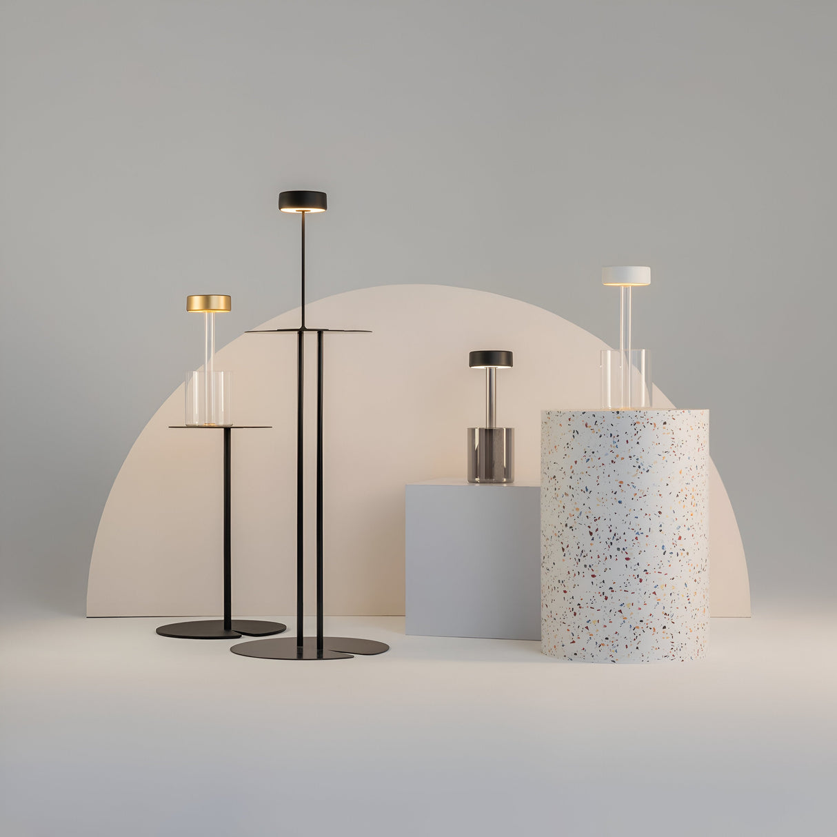 A minimalist display showcases the AI Collaboration Rechargeable LED Table Lamp with a circular base and cylindrical shade set beside a sleek glass vase on a terrazzo pedestal, all against a large semi-circular backdrop, creating a sleek and contemporary setting.