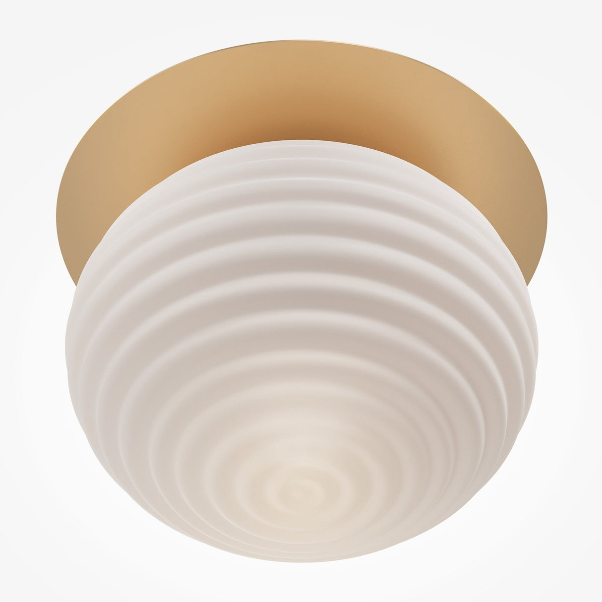 Close-up of the Reels Ceiling Light – Gold With Ribbed White Glass, featuring a round ribbed white glass shade and a circular brass base. Its modern, minimalistic design imparts a warm, soft glow.