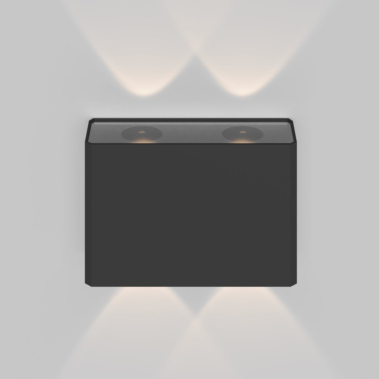 The modern Show Outdoor Wall Light 3000K in graphite is a sleek aluminum, wall-mounted fixture with dual circular LED lights, casting energy-efficient, soft light patterns upward and downward on a white wall—ideal for stylish outdoor lighting.