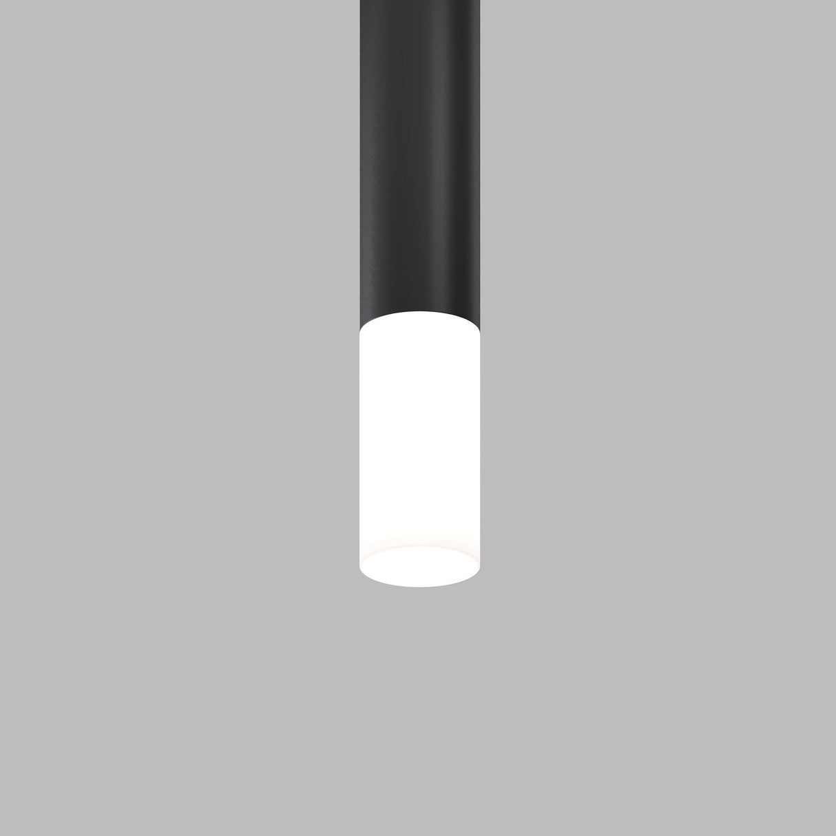The Focus LED Light Diffuser Medium 12W, a black cylindrical ceiling light with a white illuminated bottom, enhances ambient lighting against a gray background.