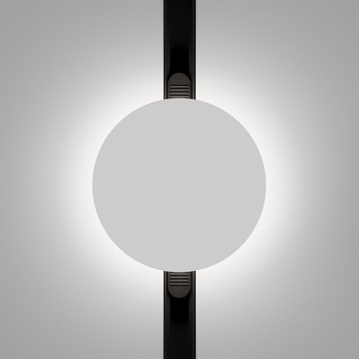 The Relax LED Magnetic Exility Track Wall/Ceiling Light 5W 3000K - Black & White features a white circular light with a soft glow intersected by a dark line, exuding minimalistic elegance for a modern, abstract effect.